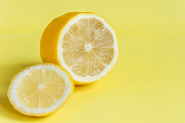 Lemon  on yellow background. Sour tropical citrus fruit.