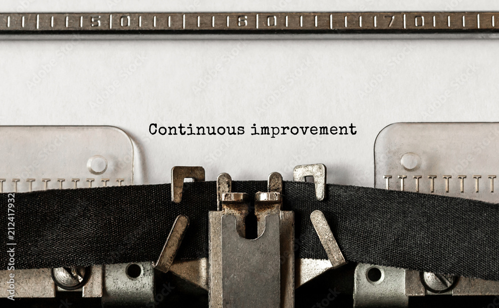 Poster text continuous improvement typed on retro typewriter