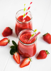 Jars with strawberry smoothie