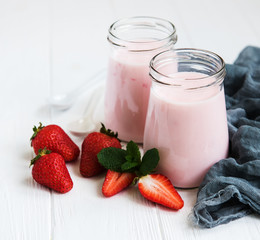 Jars with strawberry yogurt