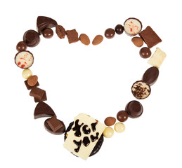 Chocolate, assorted, praline candies, almonds lined in heart shape, isolated on white