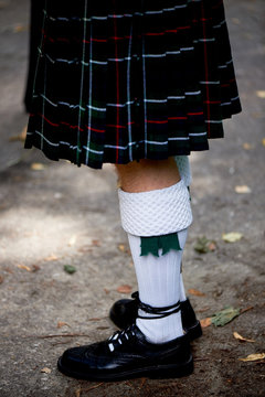 White socks and plaid Scottish kilt skirt