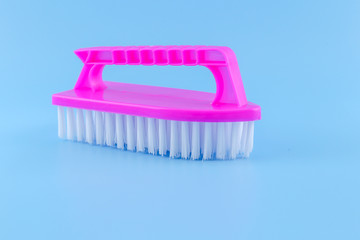 Plastic Scrub Brush on a blue background 