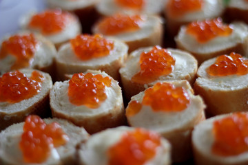 snack sandwiches with red caviar and butter