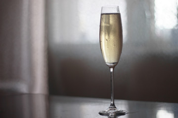 a glass of champagne on the table