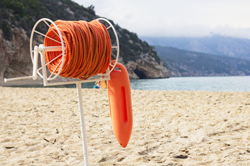Buoy and marine rescue rope on beach at Cala Luna, Sardegna 