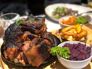 Grilled barbecue pork knuckle with baked potato