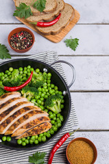 Fried chicken breast with green vegetables