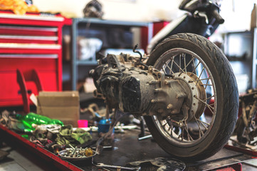 motorcycle in repair station with soft-focus and over light in the background