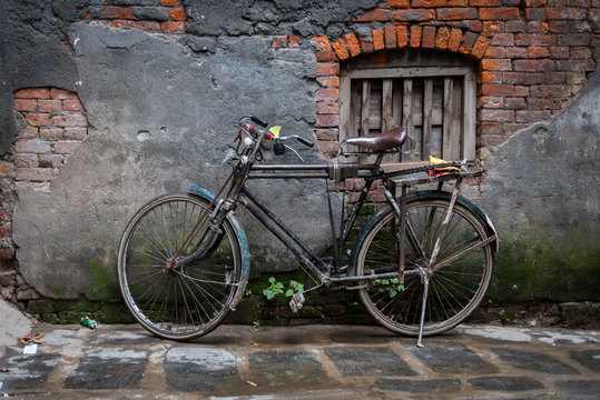 Old bicycle on its stand by a decaying old wall, Ason Tol, Kathmandu, Nepal