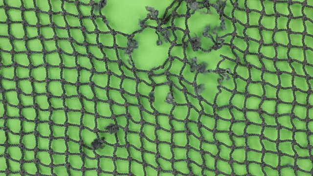 Close-up of the rotation of a torn fishing net. Isolated