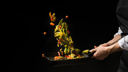 The chef prepares. Black background for copy text.Concept cooking