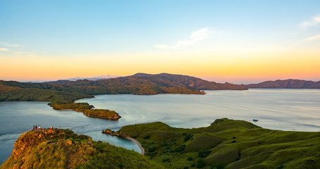 First Rays of Rising Sun in Orange Color At Gili Lawa with Clear Sky and Blue Sea. Komodo National Park, Labuan Bajo, Flores, Indonesia © Pnnchen