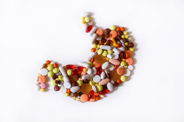 human stomach filled with pills on white background