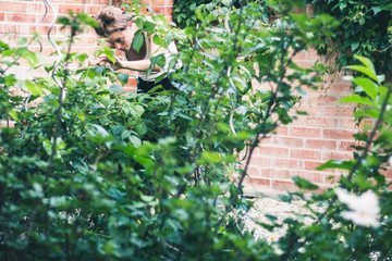 beautiful young woman in her green natural garden