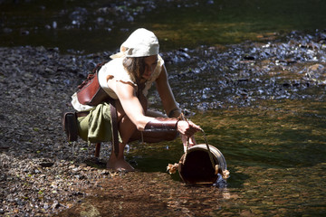 beautiful celtic woman draws water from the river 