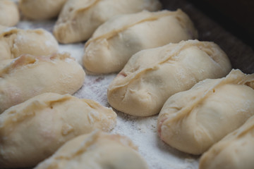 Fototapeta na wymiar Vareniki, dumplings on wooden board, traditional Ukrainian and Russian dish.