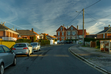 Obraz premium Country houses with fences and streets in the region of Normandy, France. Beautiful countryside, lifestyle and typical french architecture, european country landscapes