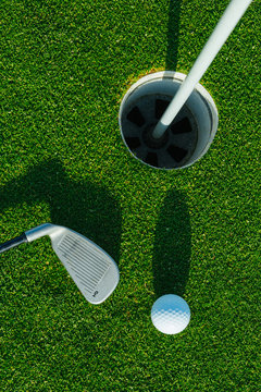 Golf ball on the green course. Close up. Top view. Sport, relax, recreation and leisure concept