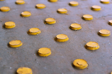 Yellow circles arranged in rows. Yellow buttons on a gray background.
