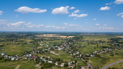 aerial view of a house in a scenic countryside hills on a sunny day