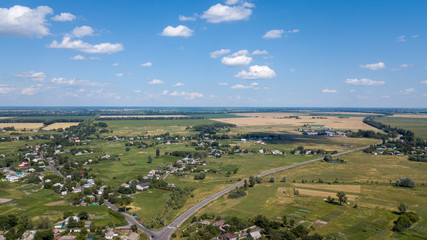 aerial view of a house in a scenic countryside hills on a sunny day