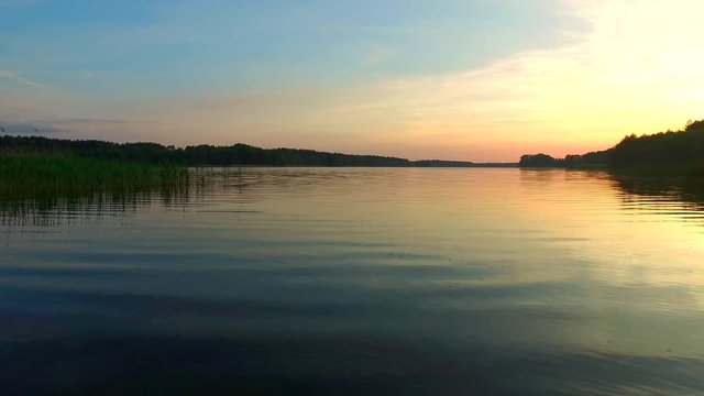Calm lake at sunset in the summer