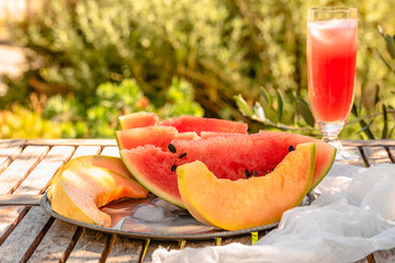 summer fruits to taste in the garden: melon and watermelon sliced whit juice