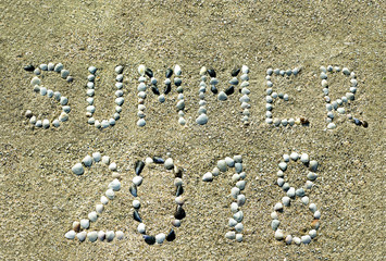 Summer of 2018, the letters are drawn on the sandy beach.