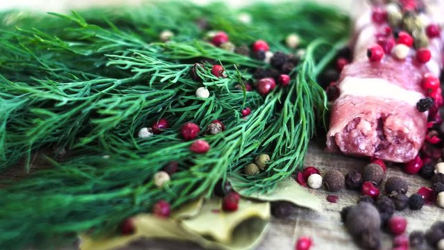 On a wooden board lined with chyvanchichi, green fresh dill, laurel leaves, a sprig is scattered from the spoon. Cooking. Posting, Macro, clouse-up