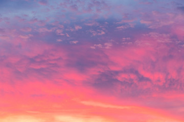 Naklejka na ściany i meble Details of clouds at sunset with dark orange, pink, and blueish purple tones