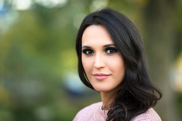 young fashion woman portrait in a park in autumn