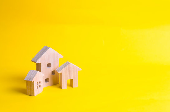 Three houses on a yellow background. Buying and selling of real estate, construction. Apartments and apartments. City, settlement. Minimalism. for presentations. real estate market.