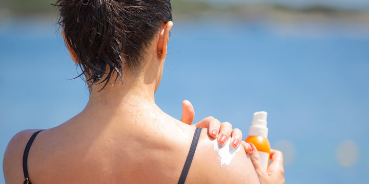 A middle-aged woman protects her skin