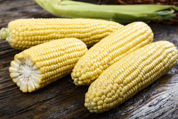 young corn on a wooden background
