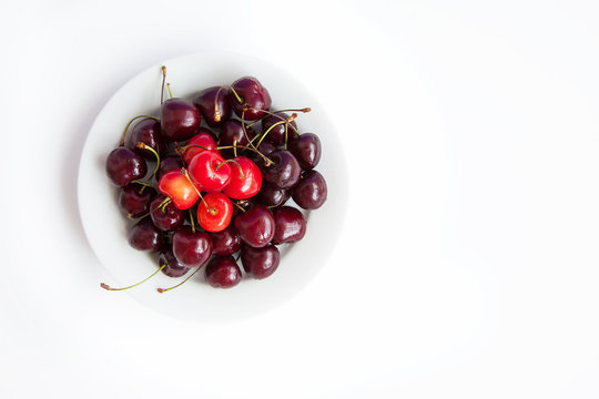 The Great Plate Of Cherries On A White Background