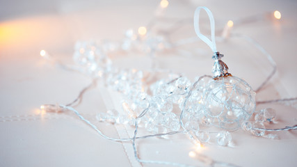 Transparent glass ball. Christmas toy. among the glittering lanterns, a garland.