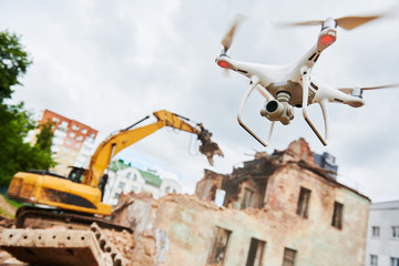 Fototapeta na wymiar Drone operated by construction worker on building site