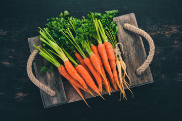 Fresh Carrot. Fresh vegetables. On a wooden background. Top view. Copy space.