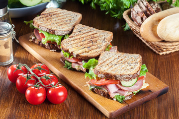Sandwiches with ham, cheese, tomatoes, lettuce and cucumber