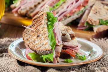 Sandwiches with ham, cheese, tomatoes, lettuce and cucumber