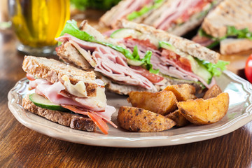 Sandwiches with ham, cheese, tomatoes, lettuce and cucumber