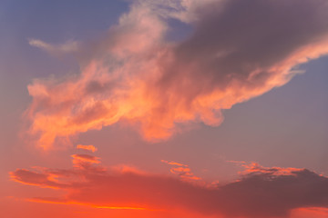 Naklejka na ściany i meble Dramatic clouds on the sky at the sunset