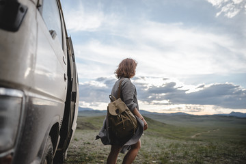 young ginger girl walking in the beautiful mountain valley