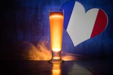 Soccer 2018. Single beer glass on table at dark toned foggy background. Support France with beer concept.