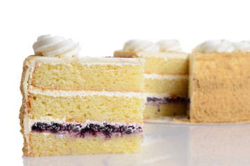 closeup slice of blueberry cream cake with frosting