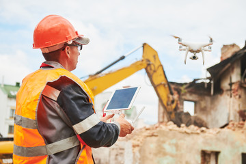 Drone operated by construction worker on building site
