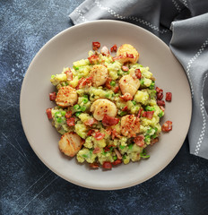 Fried scallops with mash potato, green peas and bacon