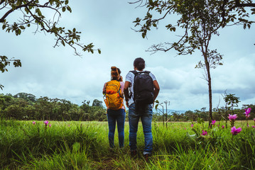Fototapeta premium Lover woman and men Asian travel nature. Travel relax. Photography Cucumber sessilis flower field.