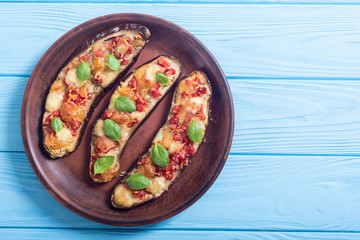 Eggplant with tomatoes , cheese and basil